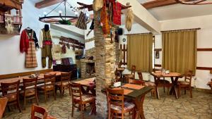 a restaurant with wooden tables and chairs in a room at Hotel Veronika Devin in Devin