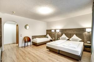 a hotel room with two beds and a mirror at Hotel Relais Königsberg in Aachen