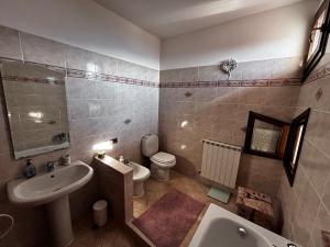 a bathroom with a sink and a toilet and a bath tub at Nido di Luna in Mulazzo +41 photos