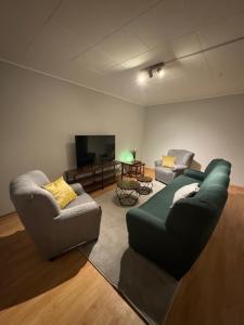 a living room with two couches and a flat screen tv at ZV38-Alter Weg-OG in Salzgitter