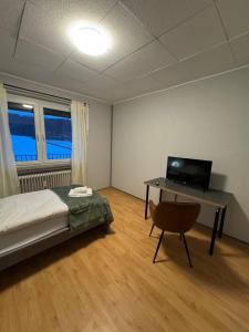 a bedroom with a bed and a desk with a computer at ZV38-Alter Weg-OG in Salzgitter