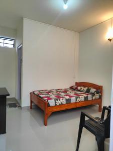 a bedroom with a bed and a chair in it at Cloud Haven in Lāitlyngkot
