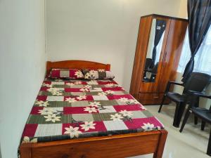 a bed with a quilt on it in a room at Cloud Haven in Lāitlyngkot +7 photos