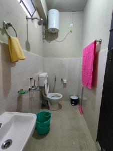 a bathroom with a white toilet and a sink at Cloud Haven in Lāitlyngkot