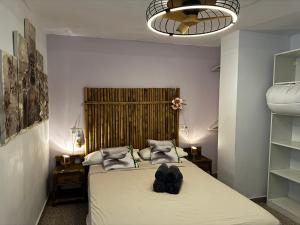 a bedroom with a bed with a pair of shoes on it at Don Quijote CABANAL in Cullera