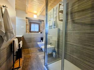 a bathroom with a glass shower and a toilet at Apartments Casa Sossa in Vilanija +56 photos