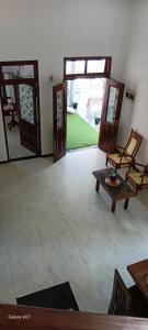 a room with two doors and a table and chairs at Wooden hostel in Weligama