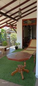 a ping pong table in the middle of a patio at Wooden hostel in Weligama