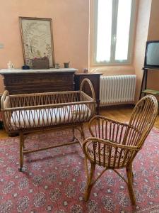 a living room with a piano and two chairs at Casa della Resistenza in Sulmona