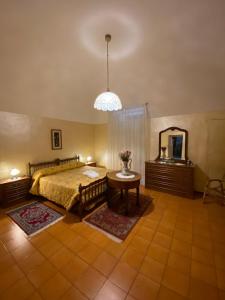 a bedroom with a bed and a table and a mirror at Casa della Resistenza in Sulmona