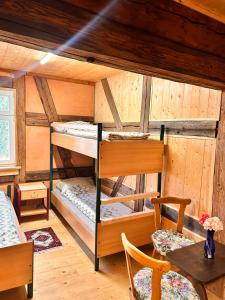 a room with two bunk beds in a cabin at Wippertaler Hütte in Kleinfurra