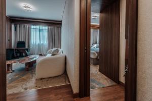 a room with a living room with a bedroom at Kuwait Continental Hotel in Kuwait