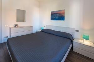 a bedroom with a bed and two dressers and a mirror at Casa Bratz in Marciana Marina