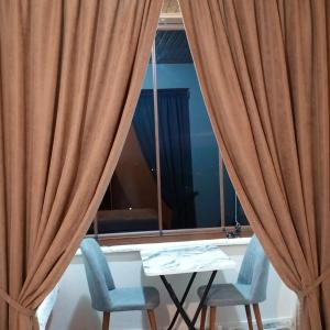 a table and two chairs and a window at Balcı Konukevi in Artvin +14 photos