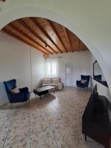 a living room with a couch and a table at Divine Island Escape in Kini