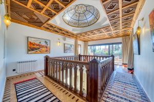 a hallway with a wooden staircase with a ceiling at Villa JUZYAN une parenthèse de bien-être et de convivialité in Marrakesh +95 photos