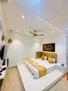 a white bedroom with a large bed with a ceiling at 3 bedroom Shreeji's Viila with Private pool in Lonavala