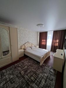 a bedroom with a large bed and a window at Cozy apartment in Kryvyi Rih