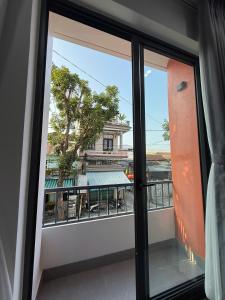 a window with a view of a building at Lien Home in Thôn An Hòa