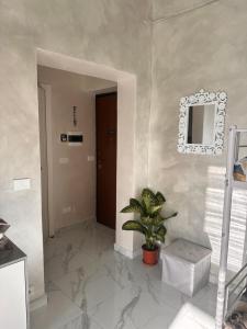 a hallway with a door and a potted plant at Chez Grenuel in Sanremo