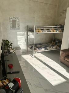 a room with two bunk beds and a table at Chez Grenuel in Sanremo +8 photos