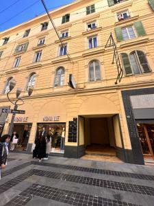 a yellow building with people standing outside of it at Chez Grenuel in Sanremo