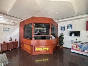 a restaurant with a large wooden buffet in a room at Hotel O Peneka Inn in Kota Bharu +117 photos