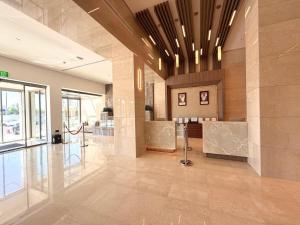 a lobby of a building with a large lobbyasteryasteryasteryasteryasteryasteryastery at Kuwait Continental Hotel in Kuwait