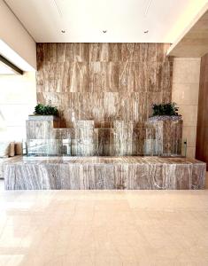 a fountain in the middle of a building at Kuwait Continental Hotel in Kuwait