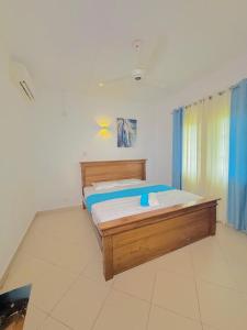 a bedroom with a wooden bed in a room at Apartment For Rent in Ambulgama +9 photos