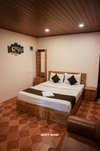 a bedroom with a large bed in a room at Vythiri Misty Wind Holiday Homes in Vythiri
