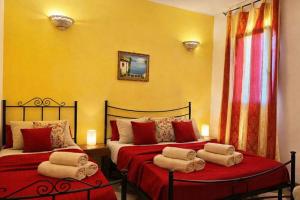 a bedroom with two beds with towels on them at Agriturismo Residence Molle con piscina in Carpignano Salentino