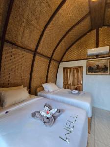 two beds in a room with a room with at Eco Moringa Garden in Banyuwedang +140 photos