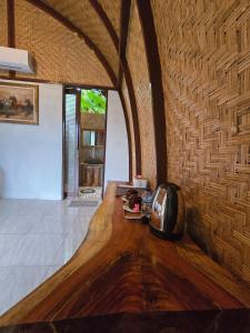 a room with a wooden table with a telephone on it at Eco Moringa Garden in Banyuwedang