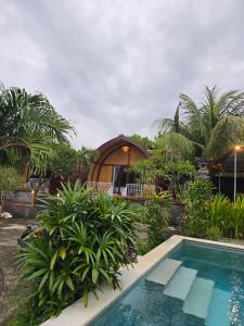 a resort with a swimming pool and a gazebo at Eco Moringa Garden in Banyuwedang