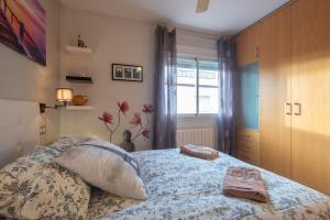 a bedroom with a bed with two towels on it at Casa modernista in La Zubia +79 photos