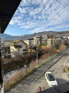 a white car parked on the side of a road at Calm & Cozy Apartment with Parking in Sallanches in Sallanches +19 photos