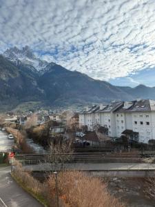a city with buildings and mountains in the background at Calm & Cozy Apartment with Parking in Sallanches in Sallanches