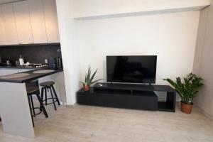 a living room with a flat screen tv on a wall at Sphynx Apartment Pipera in Voluntari