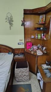 a bedroom with a bed and a desk and a table at Gem Backpackers hostel in Siliguri