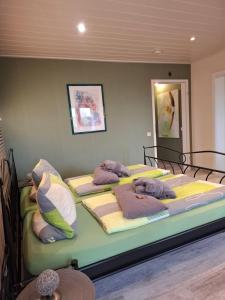 a bedroom with three beds with pillows on them at Pension-Jakobs in Nachtsheim