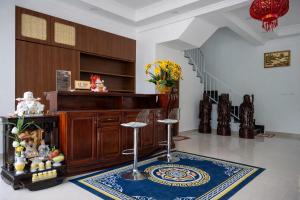 a living room with two stools and a staircase at Khách Sạn The Sum in Tây Ninh +71 photos