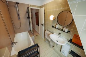a bathroom with a sink and a shower at Ferienwohnung Wirbelwind in Scharbeutz