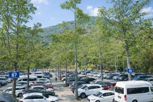 a parking lot full of cars in front of a mountain at Khách Sạn The Sum in Tây Ninh