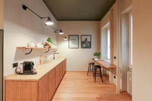 a kitchen with a counter top and a table at Cà Bèla - Venini in Milan
