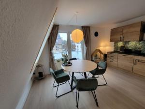 a kitchen and dining room with a table and chairs at Ferienwohnung Wirbelwind in Scharbeutz +26 photos