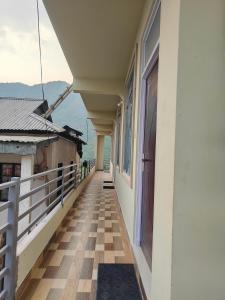 a balcony of a house with a view of the water at Cloud Haven in Lāitlyngkot