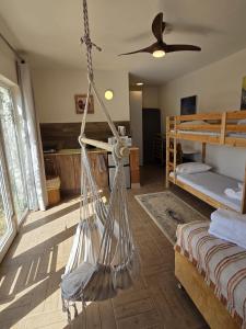 a bedroom with two bunk beds and a hammock at פסטרנק אירוח יער אודם in Odem