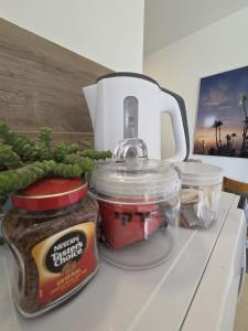 a counter top with a jar of jam and some food at פסטרנק אירוח יער אודם in Odem