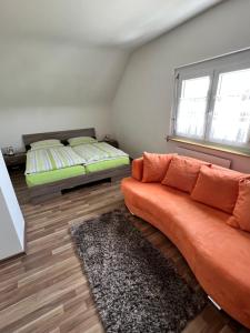 a living room with a couch and a bed at Albbruck, Feriendomizil Albsteig in Albbruck